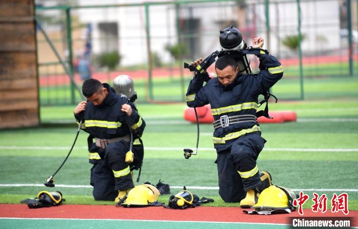 新消防員進行穿戴空呼器展示。　劉忠俊 攝